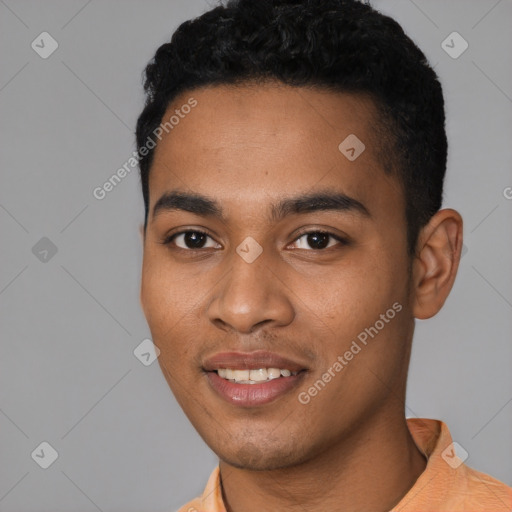 Joyful black young-adult male with short  black hair and brown eyes