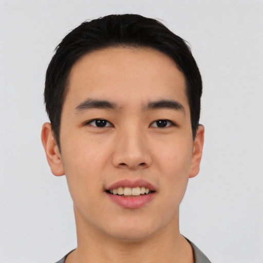 Joyful asian young-adult male with short  black hair and brown eyes