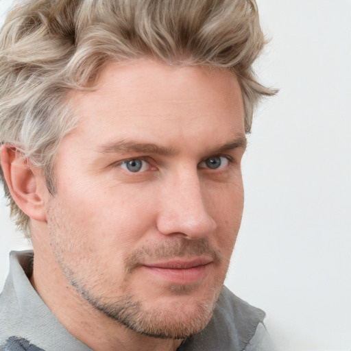 Joyful white adult male with short  brown hair and blue eyes