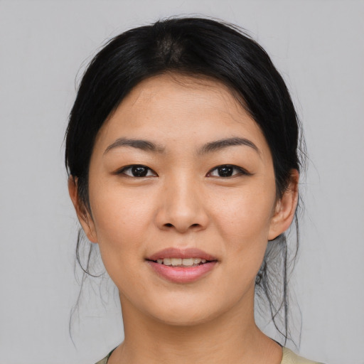 Joyful asian young-adult female with medium  black hair and brown eyes