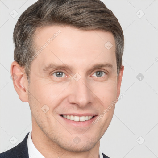 Joyful white young-adult male with short  brown hair and grey eyes