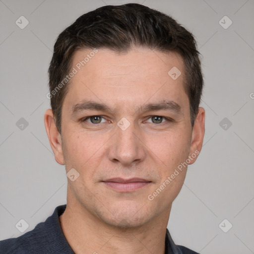 Joyful white young-adult male with short  brown hair and grey eyes