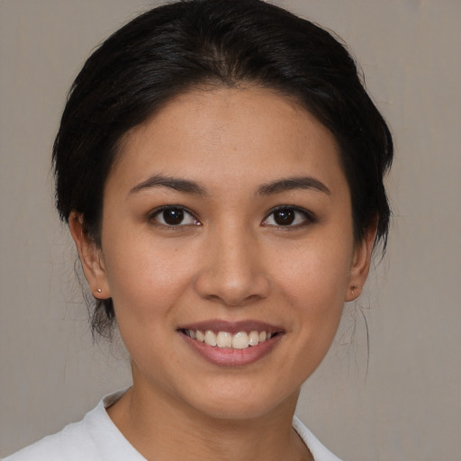 Joyful asian young-adult female with medium  brown hair and brown eyes