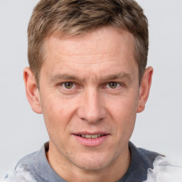 Joyful white adult male with short  brown hair and grey eyes