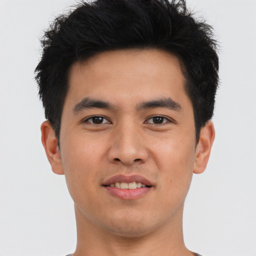 Joyful asian young-adult male with short  brown hair and brown eyes