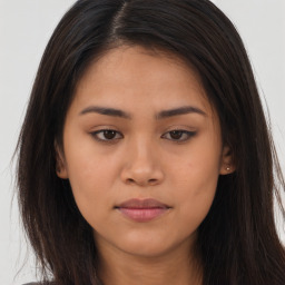 Joyful asian young-adult female with long  brown hair and brown eyes