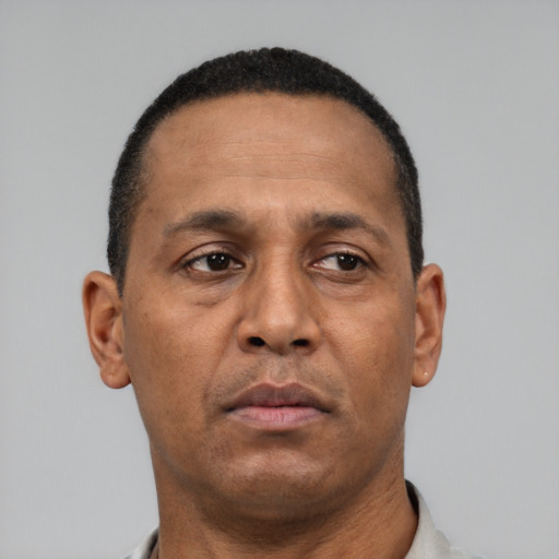 Neutral latino adult male with short  black hair and brown eyes