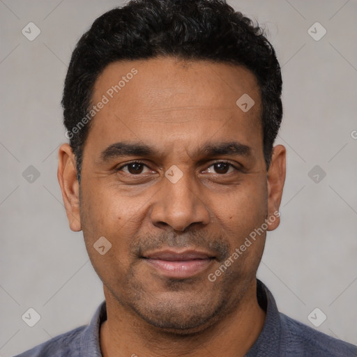 Joyful latino adult male with short  black hair and brown eyes