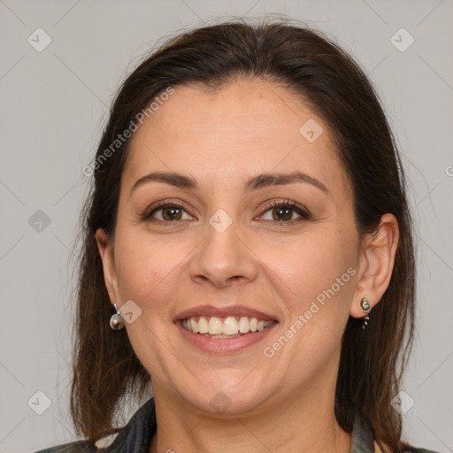 Joyful white adult female with medium  brown hair and brown eyes