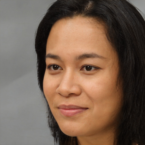 Joyful asian young-adult female with long  black hair and brown eyes