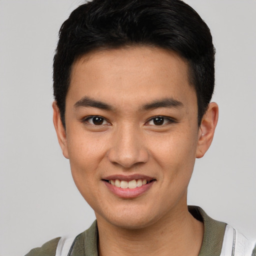 Joyful asian young-adult male with short  black hair and brown eyes