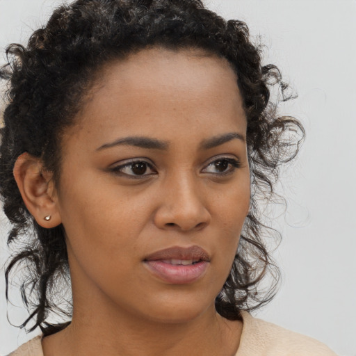 Joyful black young-adult female with medium  brown hair and brown eyes