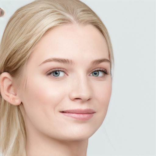 Joyful white young-adult female with long  brown hair and blue eyes