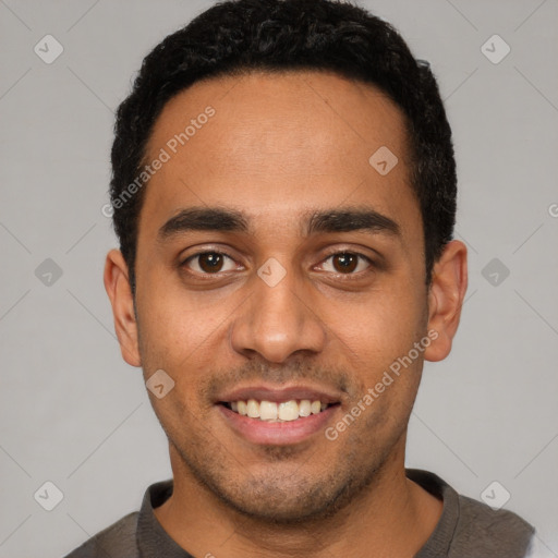 Joyful latino young-adult male with short  black hair and brown eyes