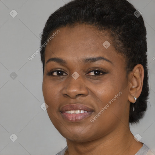 Joyful black young-adult female with short  black hair and brown eyes