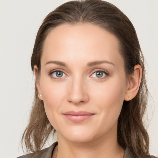 Joyful white young-adult female with long  brown hair and grey eyes