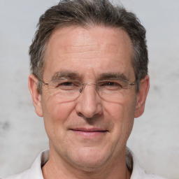 Joyful white middle-aged male with short  brown hair and brown eyes