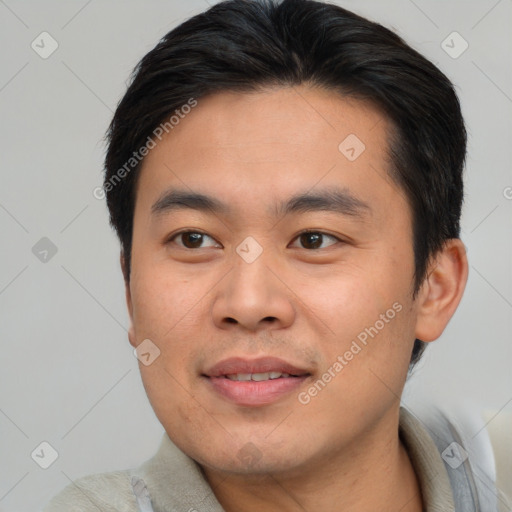 Joyful asian young-adult male with short  brown hair and brown eyes