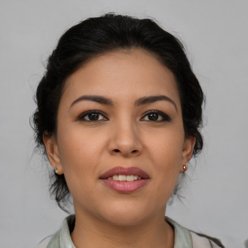Joyful latino young-adult female with medium  brown hair and brown eyes