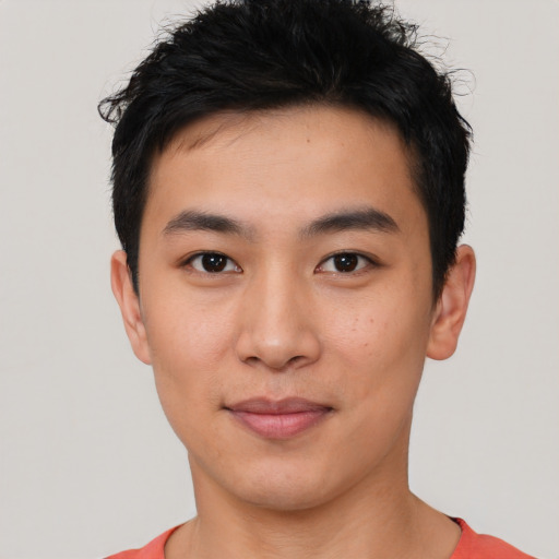 Joyful asian young-adult male with short  black hair and brown eyes