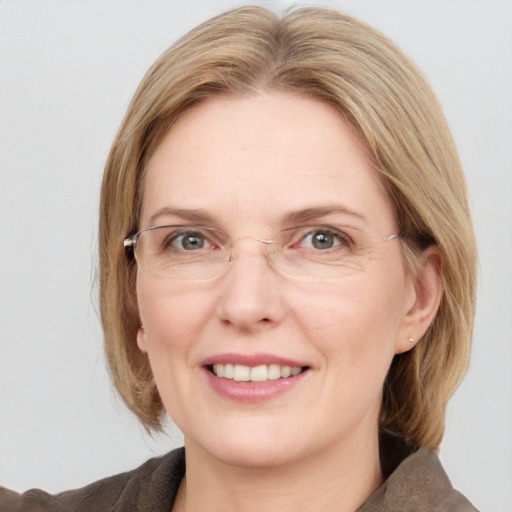 Joyful white adult female with medium  brown hair and blue eyes