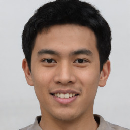 Joyful asian young-adult male with short  black hair and brown eyes