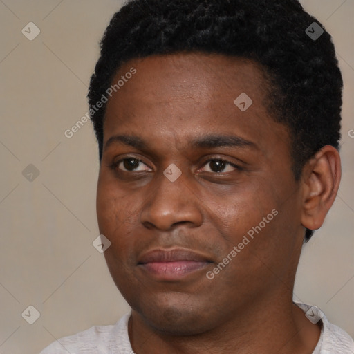 Joyful black young-adult male with short  black hair and brown eyes