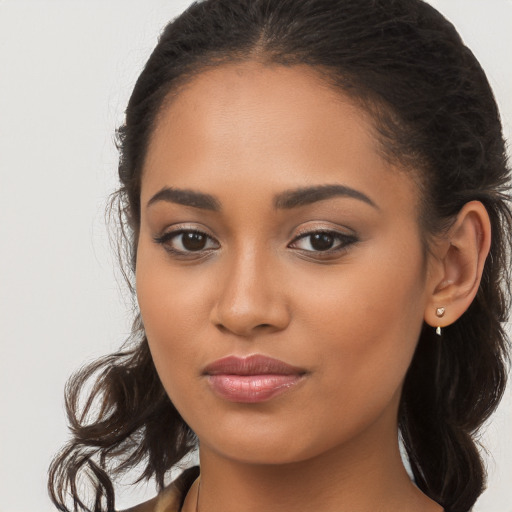 Joyful latino young-adult female with long  brown hair and brown eyes