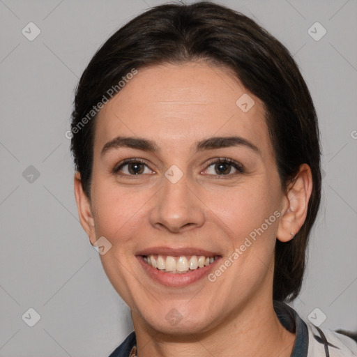 Joyful white adult female with medium  brown hair and brown eyes