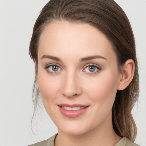 Joyful white young-adult female with long  brown hair and grey eyes