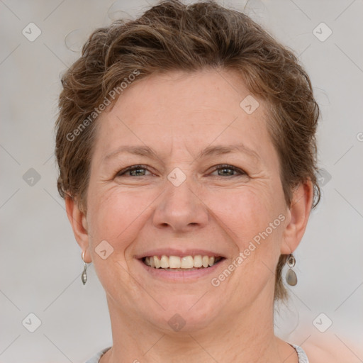 Joyful white adult female with short  brown hair and grey eyes