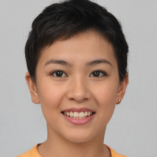 Joyful asian young-adult female with short  brown hair and brown eyes