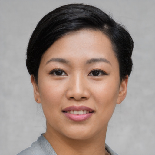 Joyful asian young-adult female with short  black hair and brown eyes