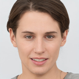 Joyful white young-adult female with short  brown hair and grey eyes