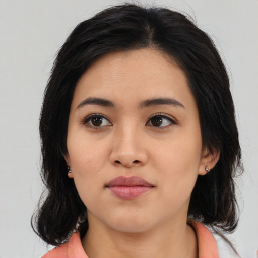 Joyful asian young-adult female with medium  black hair and brown eyes