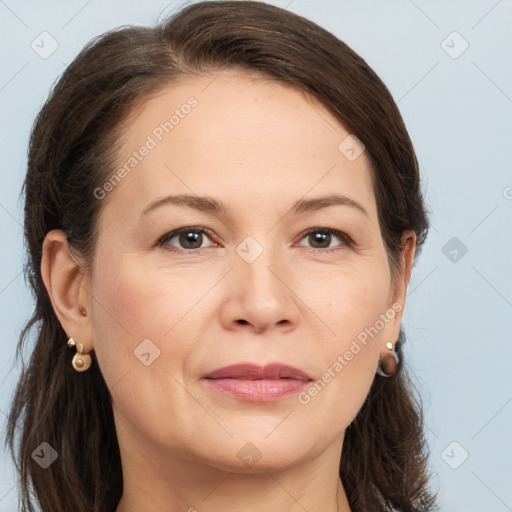 Joyful white adult female with long  brown hair and brown eyes