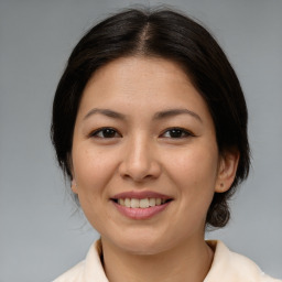 Joyful asian young-adult female with medium  brown hair and brown eyes