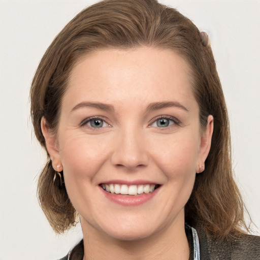 Joyful white young-adult female with long  brown hair and grey eyes