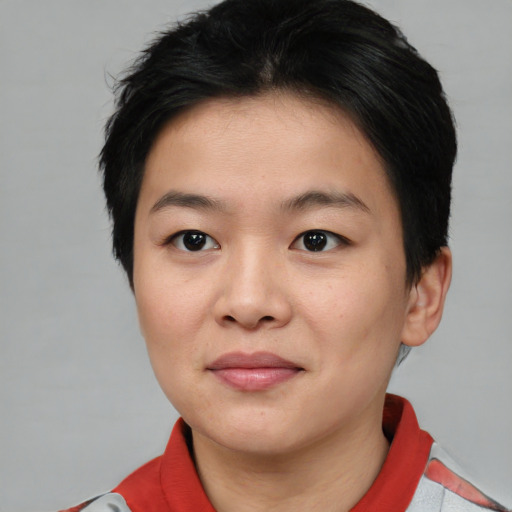Joyful asian young-adult female with short  brown hair and brown eyes