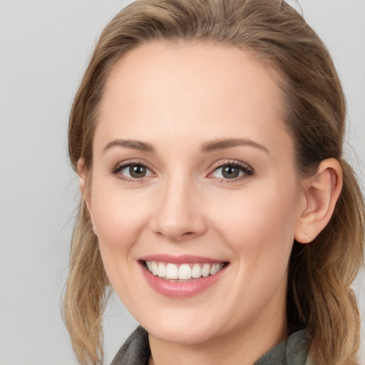 Joyful white young-adult female with long  brown hair and grey eyes