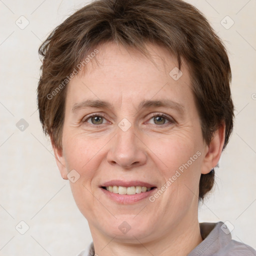 Joyful white adult female with short  brown hair and grey eyes