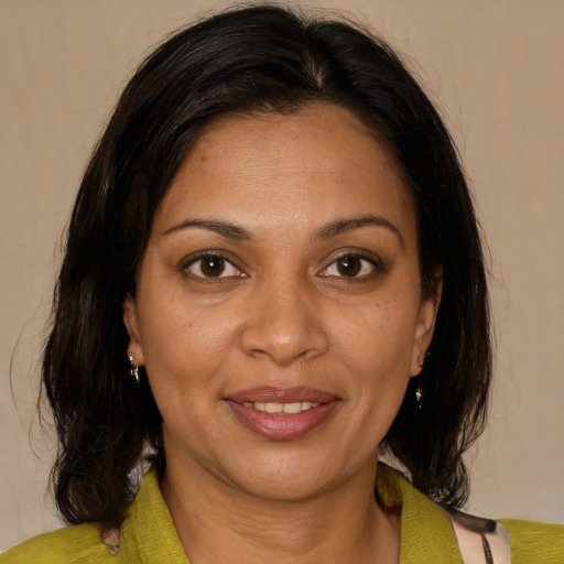 Joyful black adult female with medium  brown hair and brown eyes
