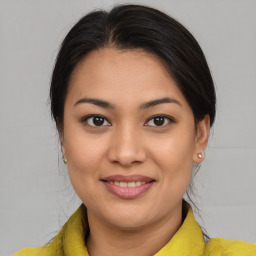 Joyful latino young-adult female with medium  brown hair and brown eyes