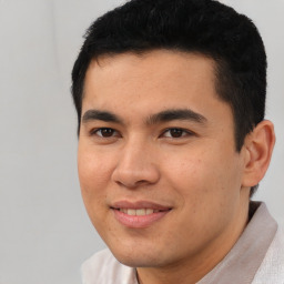 Joyful latino young-adult male with short  black hair and brown eyes