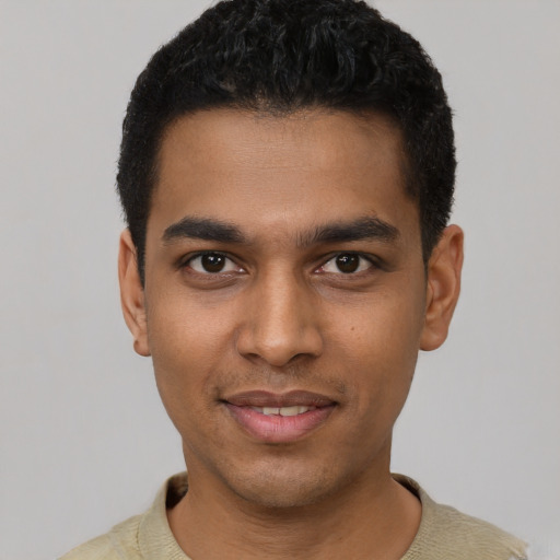 Joyful latino young-adult male with short  black hair and brown eyes