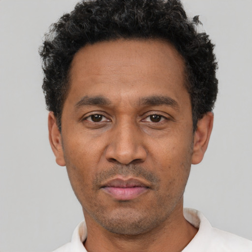 Neutral latino adult male with short  black hair and brown eyes