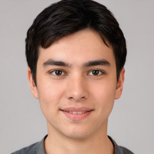 Joyful white young-adult male with short  black hair and brown eyes