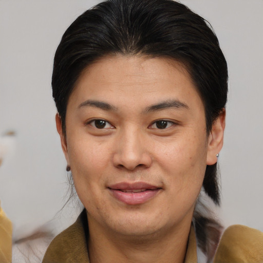 Joyful asian adult female with short  brown hair and brown eyes