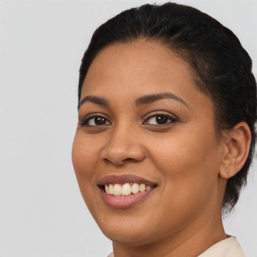Joyful latino young-adult female with short  black hair and brown eyes