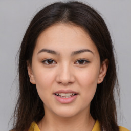 Joyful asian young-adult female with long  brown hair and brown eyes